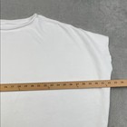 White 100% cotton funnel neck capelet with long sleeves, shown flat beside a wooden ruler for scale.