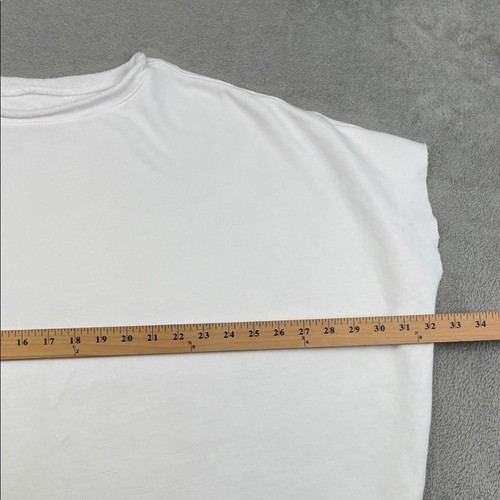 White 100% cotton funnel neck capelet with long sleeves, shown flat beside a wooden ruler for scale.