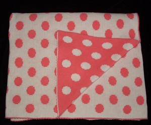 pink blanket with white polka dots