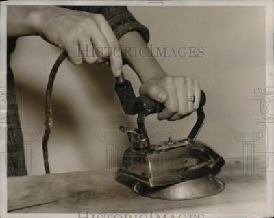 1937 Press Photo Electric Iron placed on a metal stand to prevent fires