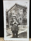 Antique 1910s Snapshot Photo Man Holding Cat in Front of House Vtg Black & White