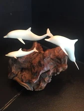 B27) Signed John Perry Art Sculpture with 3 White Dolphins on Burlwood
