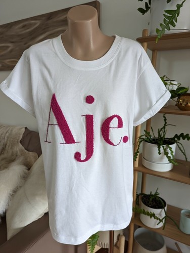 Aje white t-shirt with pink logo size 