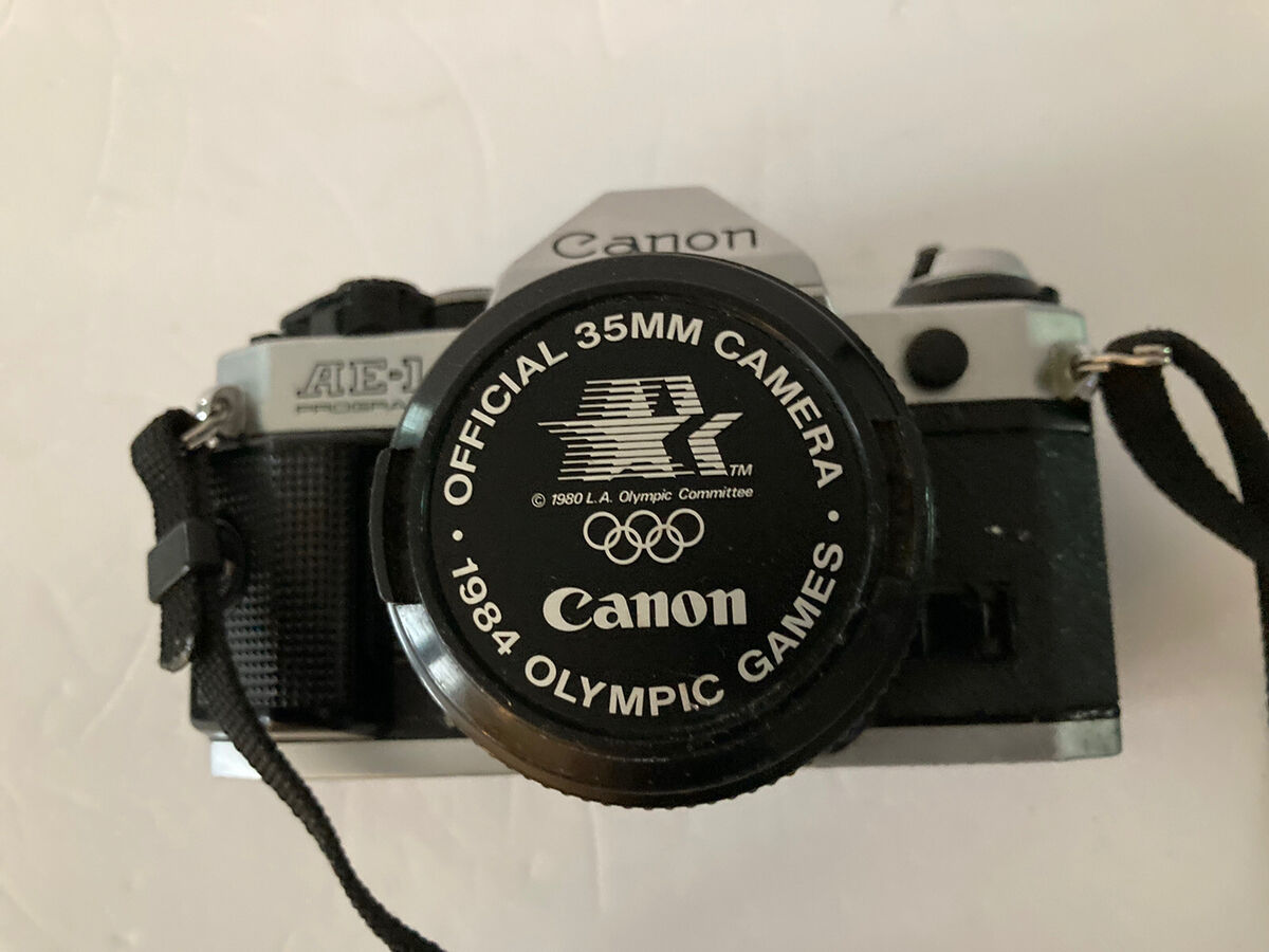Canon AE-1 Program 35mm Camera 1984 Olympic Games Lens Cap Canon AE-1 Program 35mm Camera 1984 Olympic Games Lens Cap