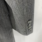 Vintage Christian Dior grey suit jacket with textured fabric, three-button front closure, and long sleeves.