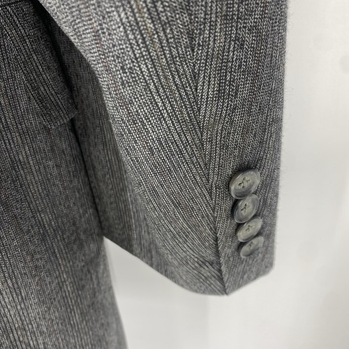 Vintage Christian Dior grey suit jacket with textured fabric, three-button front closure, and long sleeves.