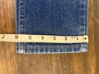 Wrangler blue denim kids’ jeans, size 7 reg, with yellow measuring tape across the waistband.