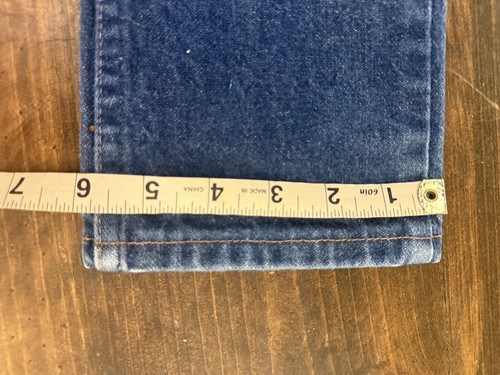 Wrangler blue denim kids’ jeans, size 7 reg, with yellow measuring tape across the waistband.