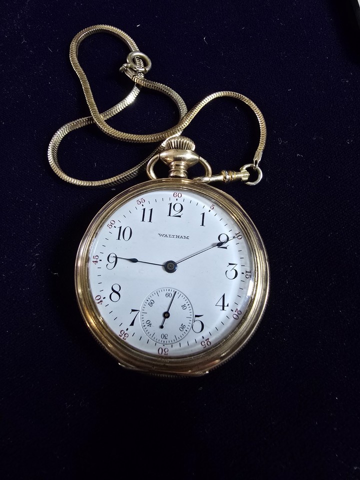 A working antique Waltham pocket watch with a clean dial, gold-filled case, and chain — a genuinely heirloom-quality gift.