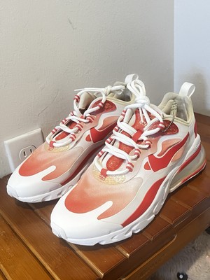 Nike Air Max 270 React SE in white with vibrant red and orange accents