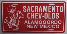 1980's SACRAMENTO CHEV-OLDS DEALERSHIP ALAMOGORDO NM BOOSTER License Plate 