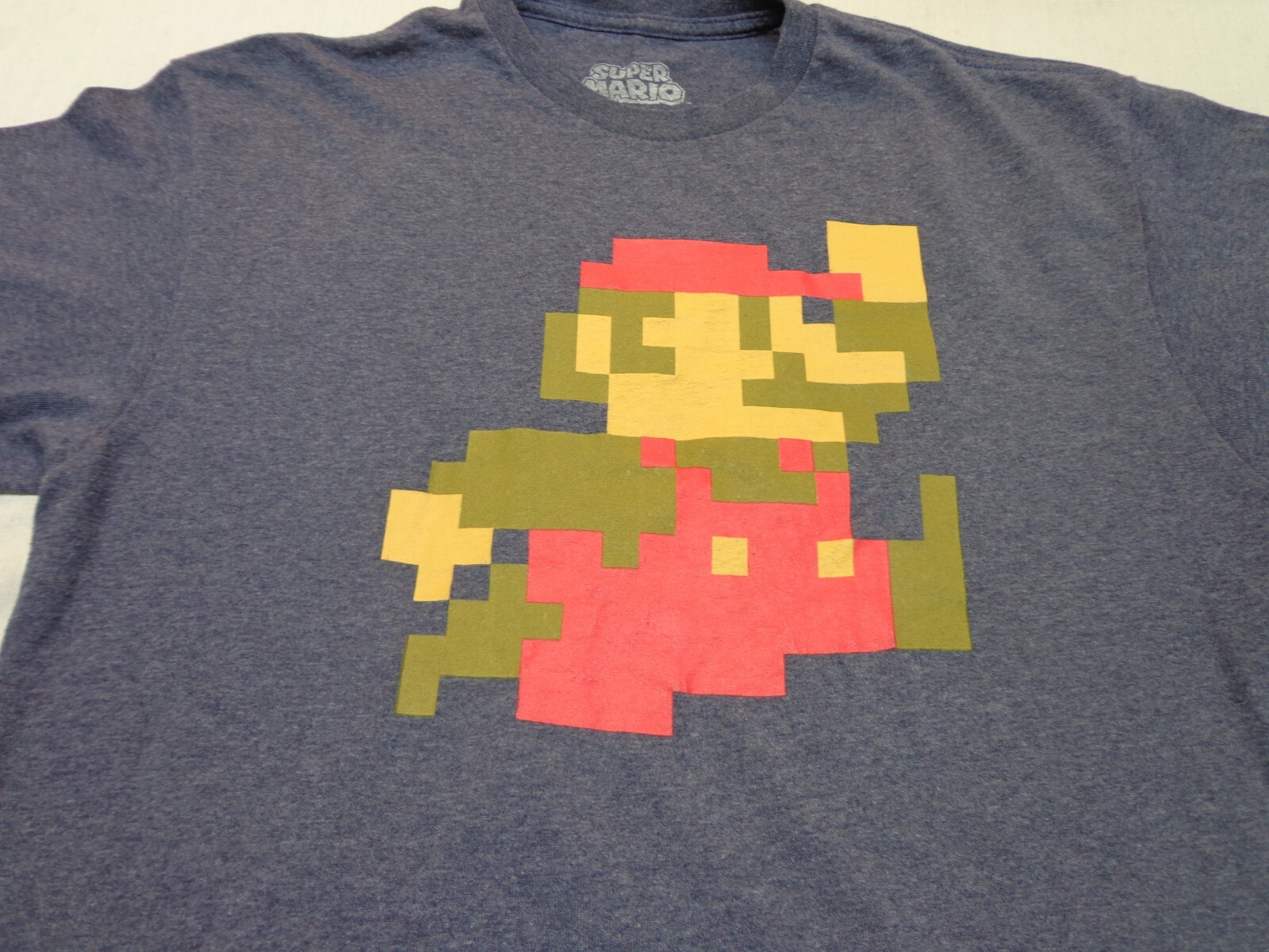 Camiseta Nintendo Super Mario Bros Pixels Azul Jaspeado Talla Grande
