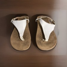 Vionic Kirra sandals feature a T-strap design and gold-tone buckle hardware.