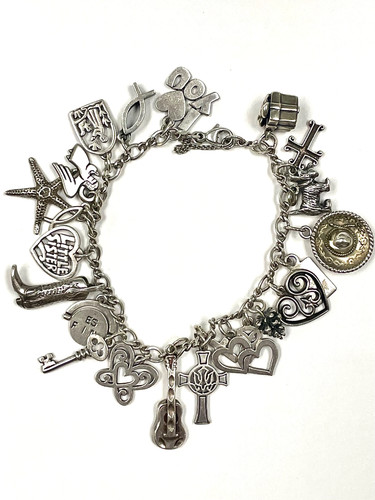 JAMES AVERY STERLING SILVER CHARM BRACELET WITH 23 VINTAGE OR RETIRED CHARMS