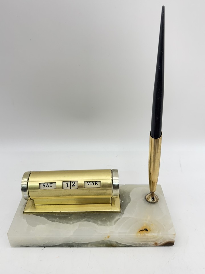 A perpetual desk calendar on an onyx and brass base — mid-century modern perfection that never needs a battery and looks incredible doing it.