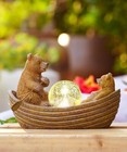 Two Brown Bears Rowing Solar Statue with Solar Ball in the Middle of the Boat