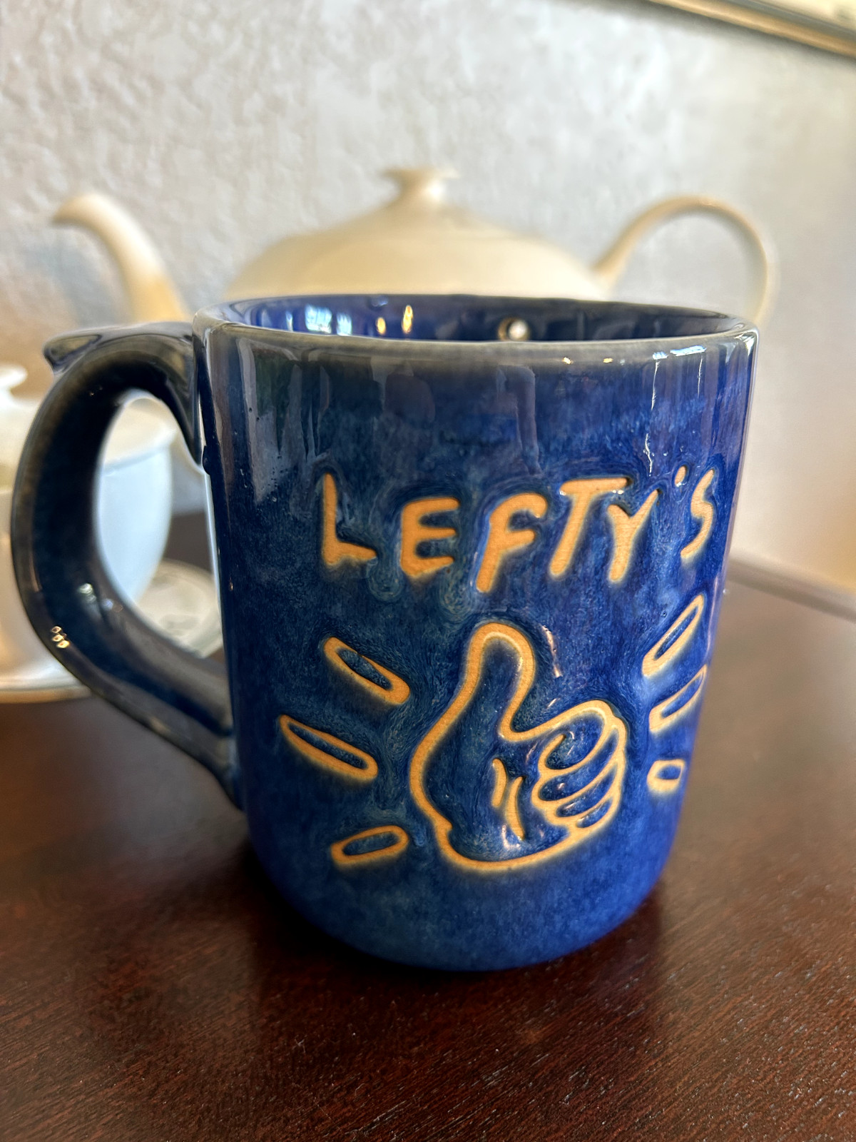 Lefty's blue terra cotta "dribble" mug for left-handed people