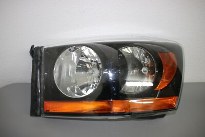 2006 DODGE PU NEW SYTLE R1500 MEGA CAB  LEFT SIDE HEADLIGHT BLACK BEZEL