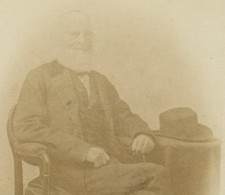 WILLIAM CULLEN BRYANT, POET, SEATED AT TABLE WITH HAT. CABINET CARD.