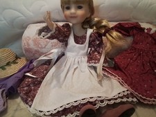 Ruby red doll , with seven outfits
