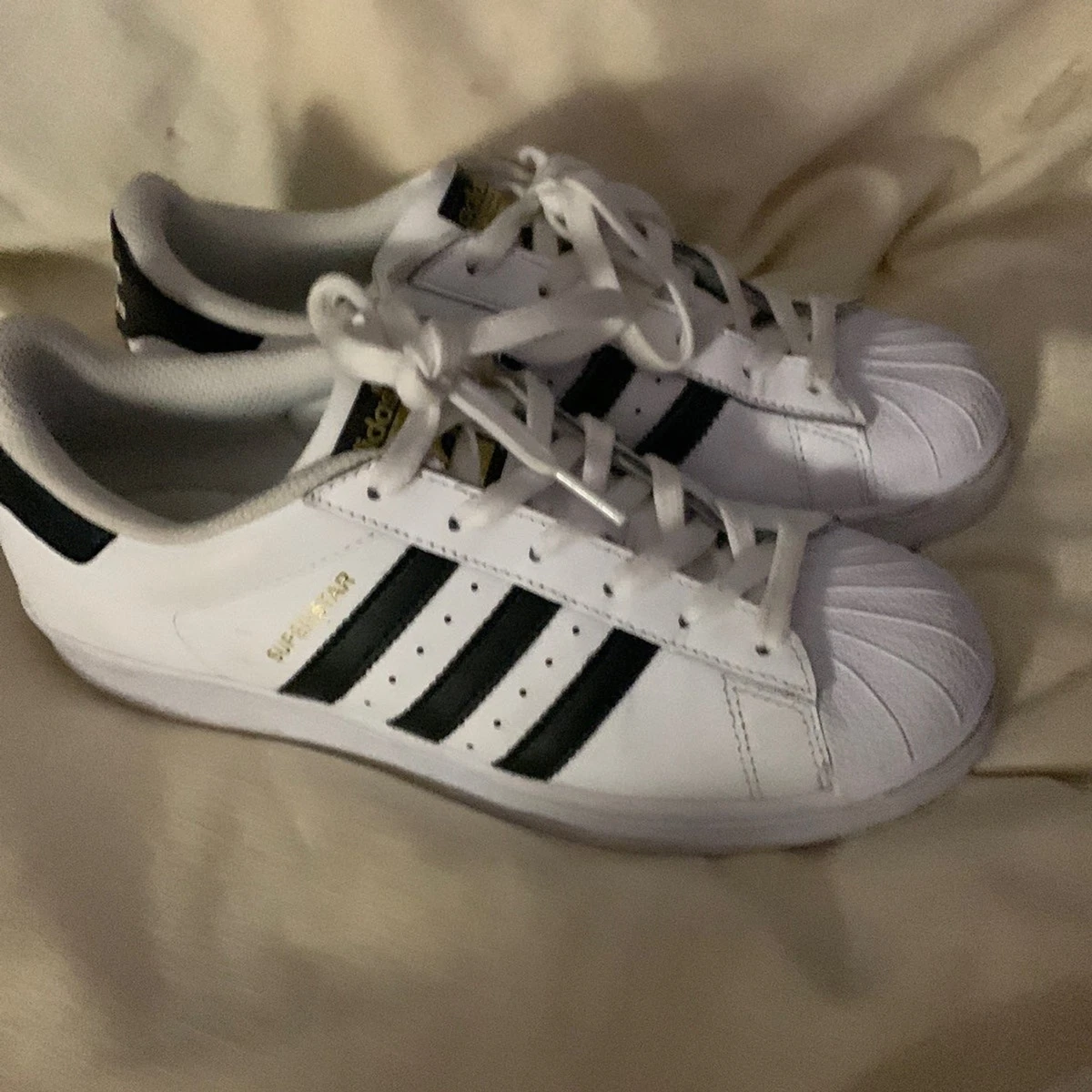 Adidas Superstar White with 3 stripe black accents. Ladies size 7