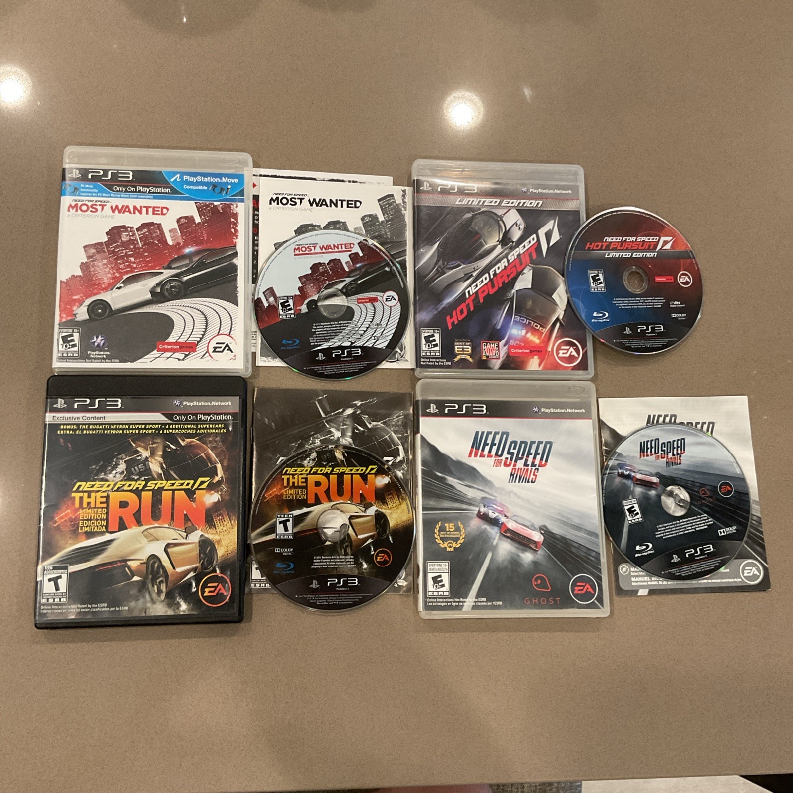 PS3 Need for Speed Most Wanted Hot Pursuit Rivals Run cases with white sports cars and neon-lit city streets.