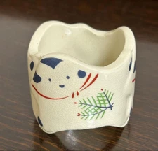 A dog-shaped lid rest with pine, bamboo, and plum design, made by Sen Art