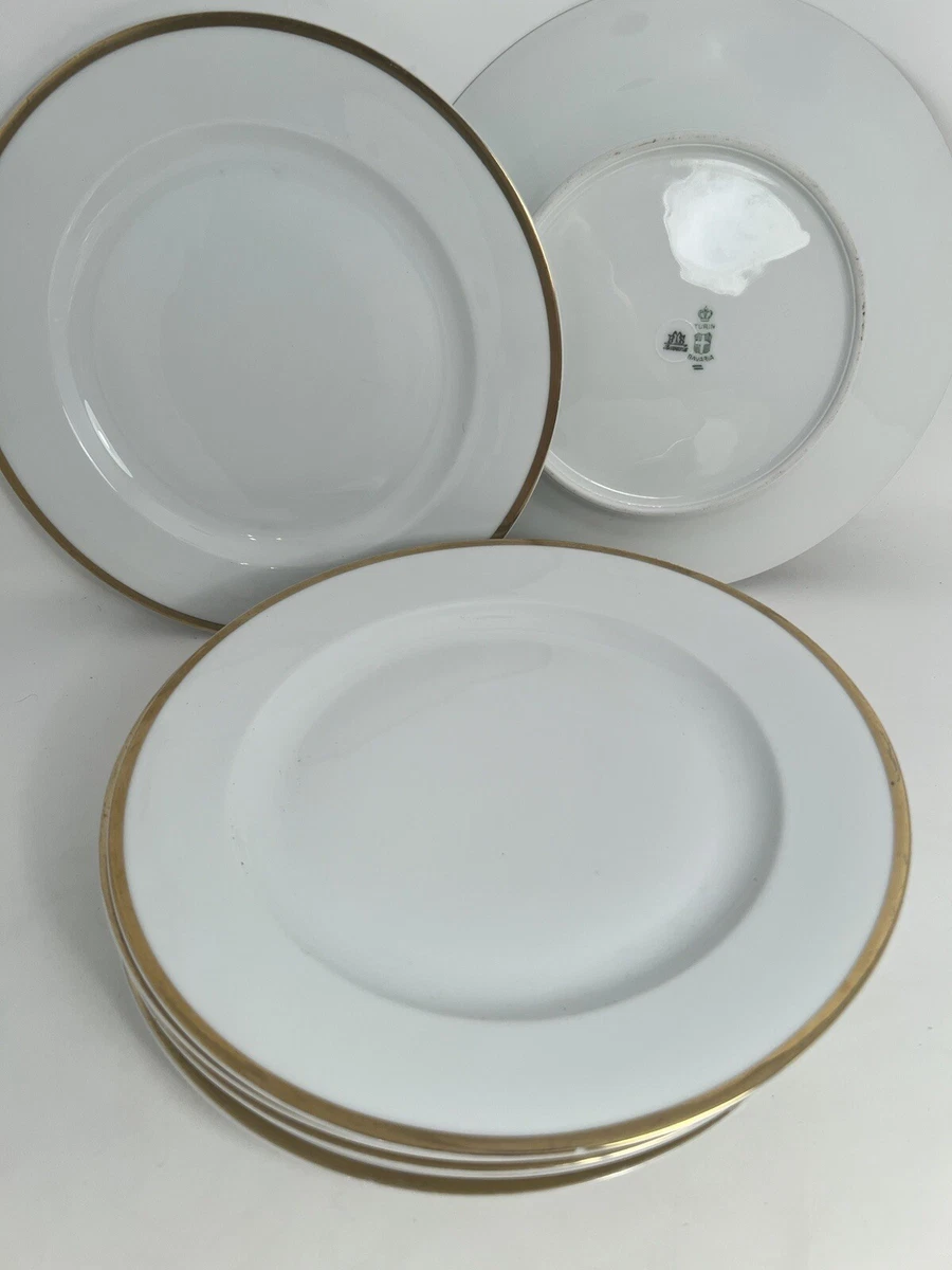 White dinner plates top with gold trim