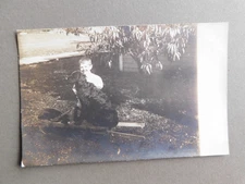 Postcard vintage RPPC - Boy with Black Dog  in yard