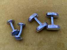 A Pair Of White Metal Cufflinks, One Set With Blue Stones At Ends