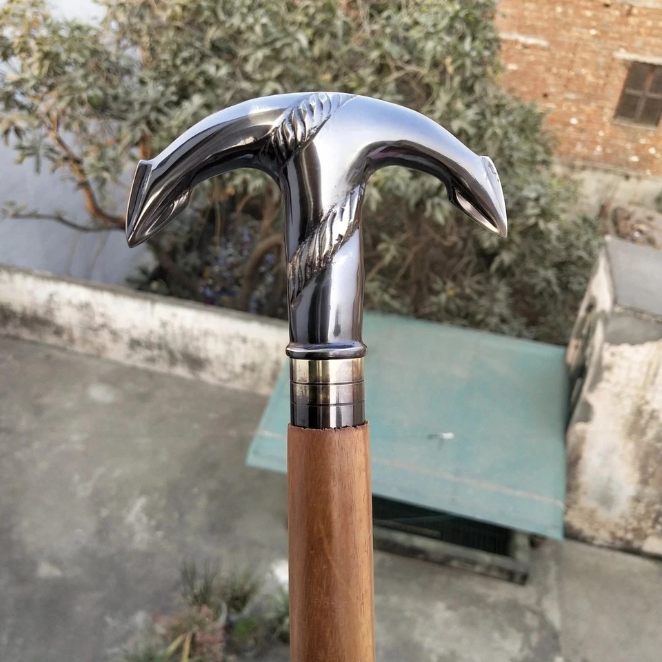 A brass anchor-topped walking cane with Victorian nautical flair — equal parts functional gentleman's accessory and conversation-starting antique prop.