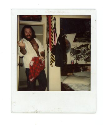 Scruffy burly hairy man  with thick beard giving finger Vintage snapshot  photo