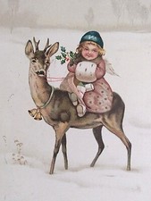 A Happy Christmas Girl with Muff Riding a Deer Angel Bells Holly Postcard c1910s