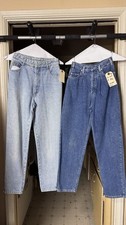 Two pairs of vintage denim jeans in light and dark wash. 1980E S Size
