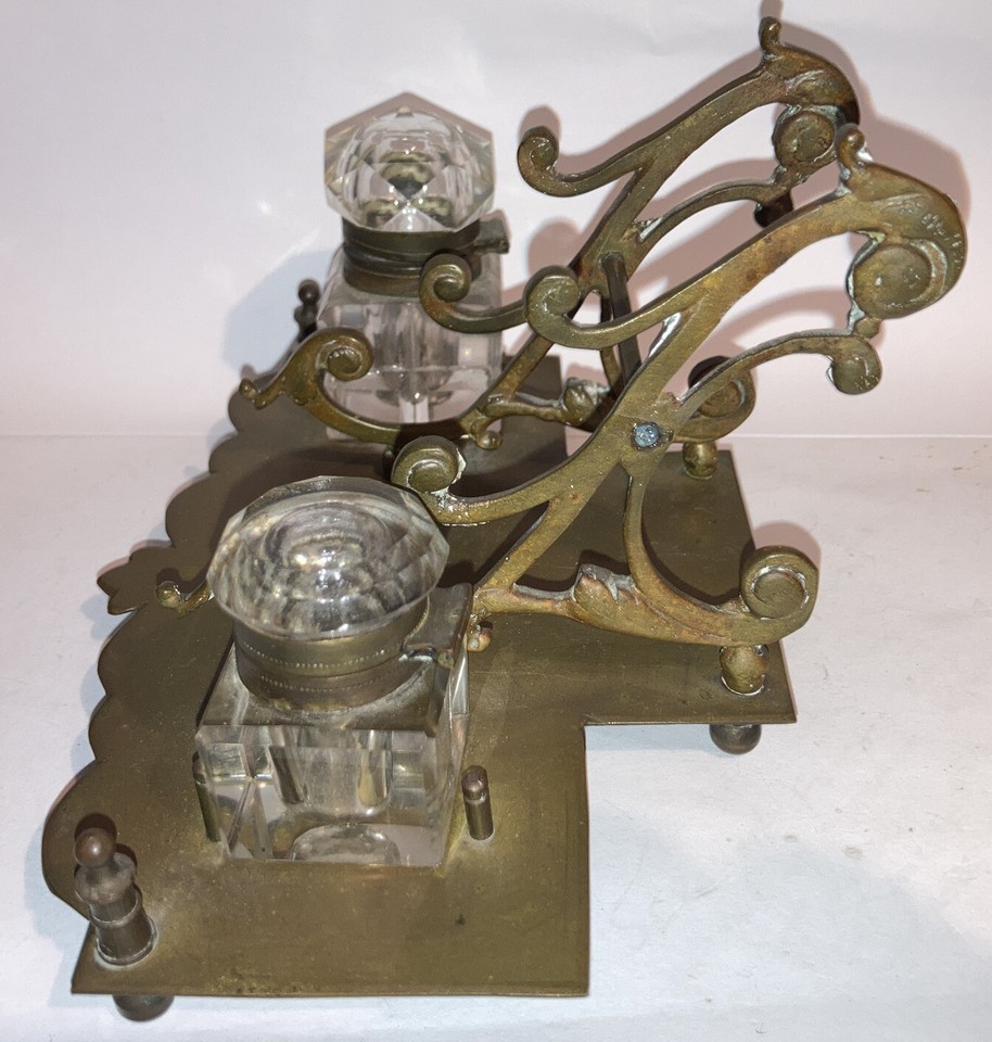 A genuine 1800s brass double inkwell with pen rest — the kind of desk piece that makes visitors stop and ask questions.