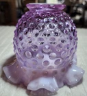 A  Fenton opalescent hobnail glass vase with a ruffled rim