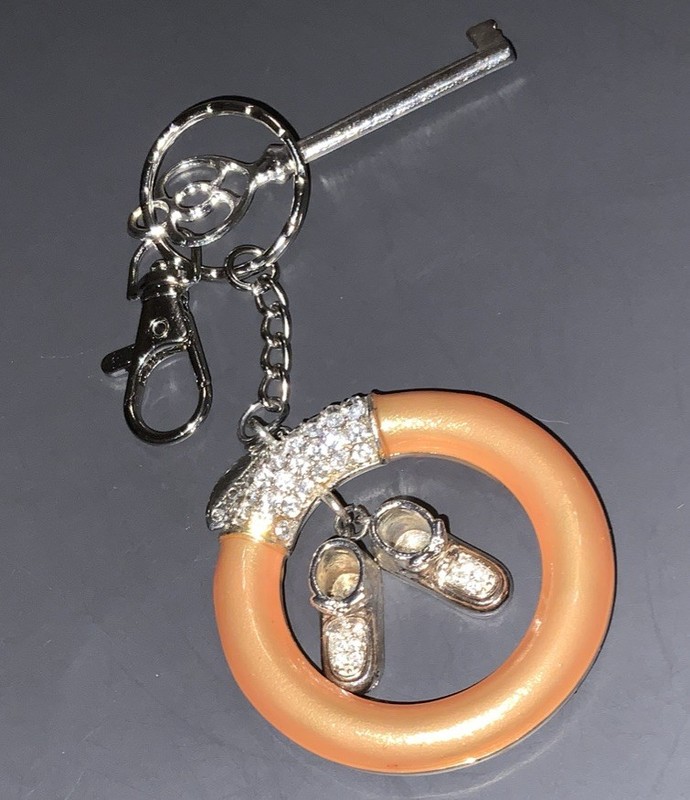 A Mark Up Of A Baby Teething Ring Keychain With Rhinestones