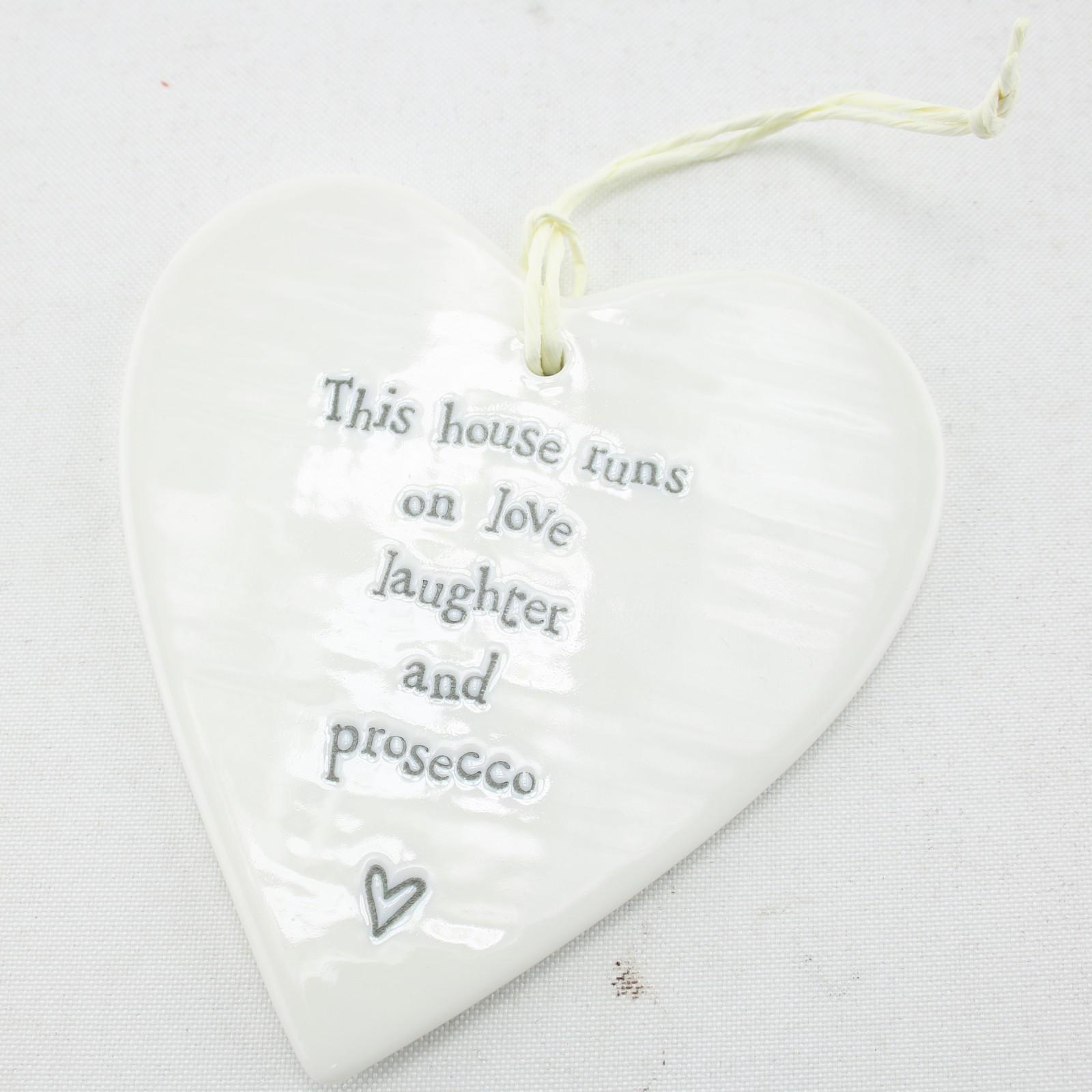 East of India Porcelain Hanging heart This House Runs on Laughter & Proesecco