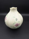 Cream round LENOX MORNINGSIDE vase with gold rim, purple floral accents, and green leaves on a dark background.