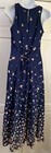 Navy blue midi dress with small white floral print, lace-up front detail, and scoop neckline on mannequin.