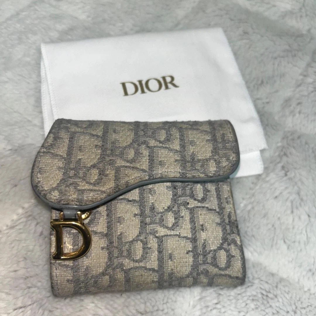 Portefeuille femme Dior selle lotus oblique jacquard occasion avec signes d'usure
