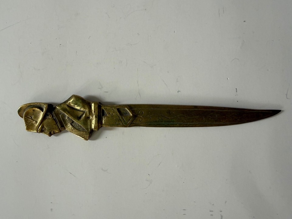 A brass figural Napoleon Bonaparte letter opener — equal parts functional tool and history-nerd flex sitting on your desk.
