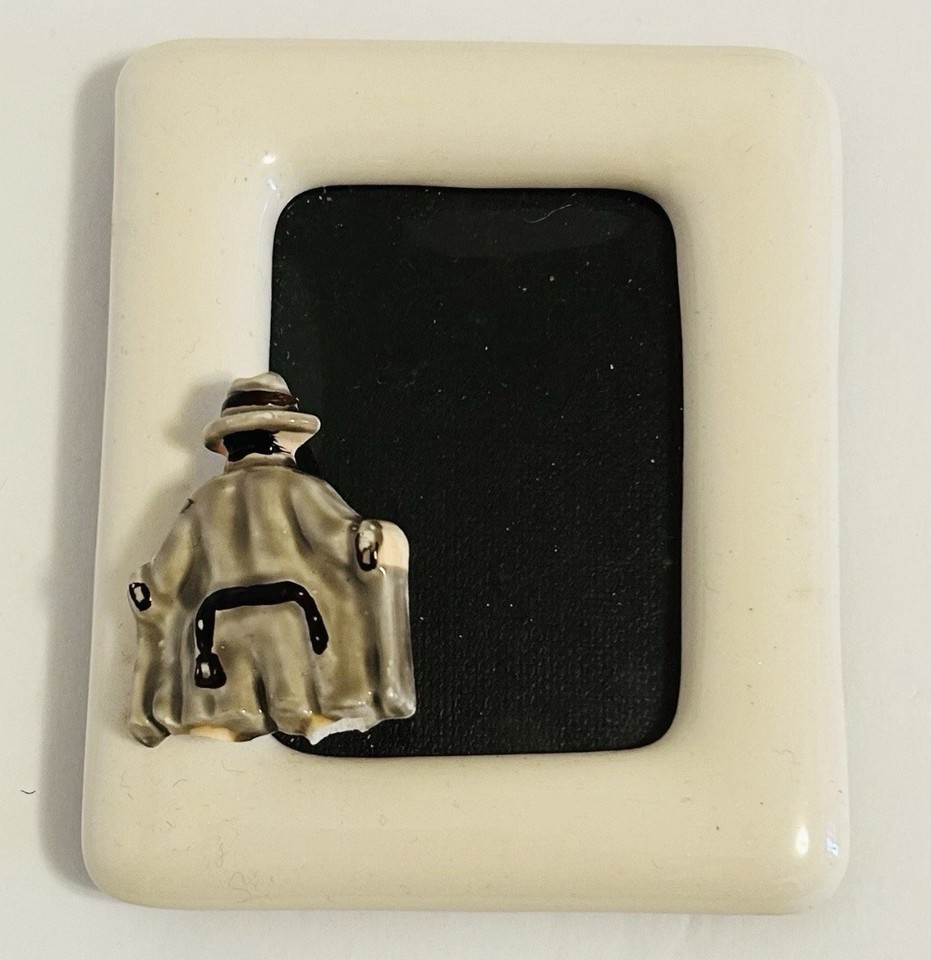 A 1981 ceramic 'flasher' novelty picture frame — the trench-coat-opening gag immortalized in fired clay is peak vintage adult humor.