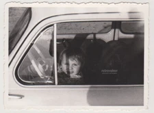 Smiling Little Boy in the Driver's Seat Playful Moment Captured on the Road Phot