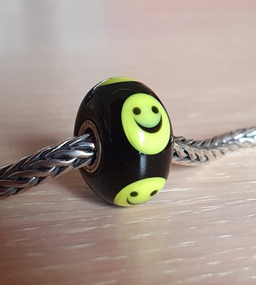 AUTHENTIC TROLLBEADS A BLACK SMILEY WITH A YELLOW FACE, HE IS MARKED LAA.