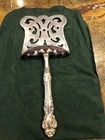 Elegant Reed & Barton asparagus server. Pre-owned Sterling silver handle. 9 3/4”