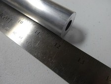 12" LONG 1" DIA. ALUMINUM ROUND BAR WITH 7/16" CENTER HOLE.