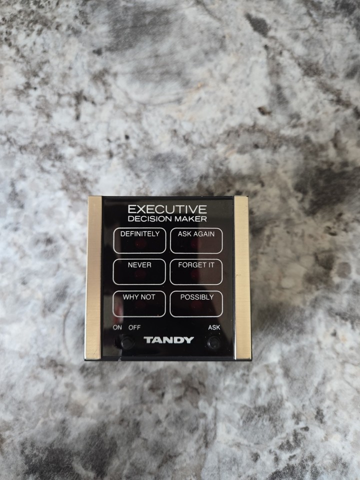 A vintage Radio Shack 'Executive Decision Maker' novelty gadget — essentially a magic 8-ball for the corporate desk, tested and working.