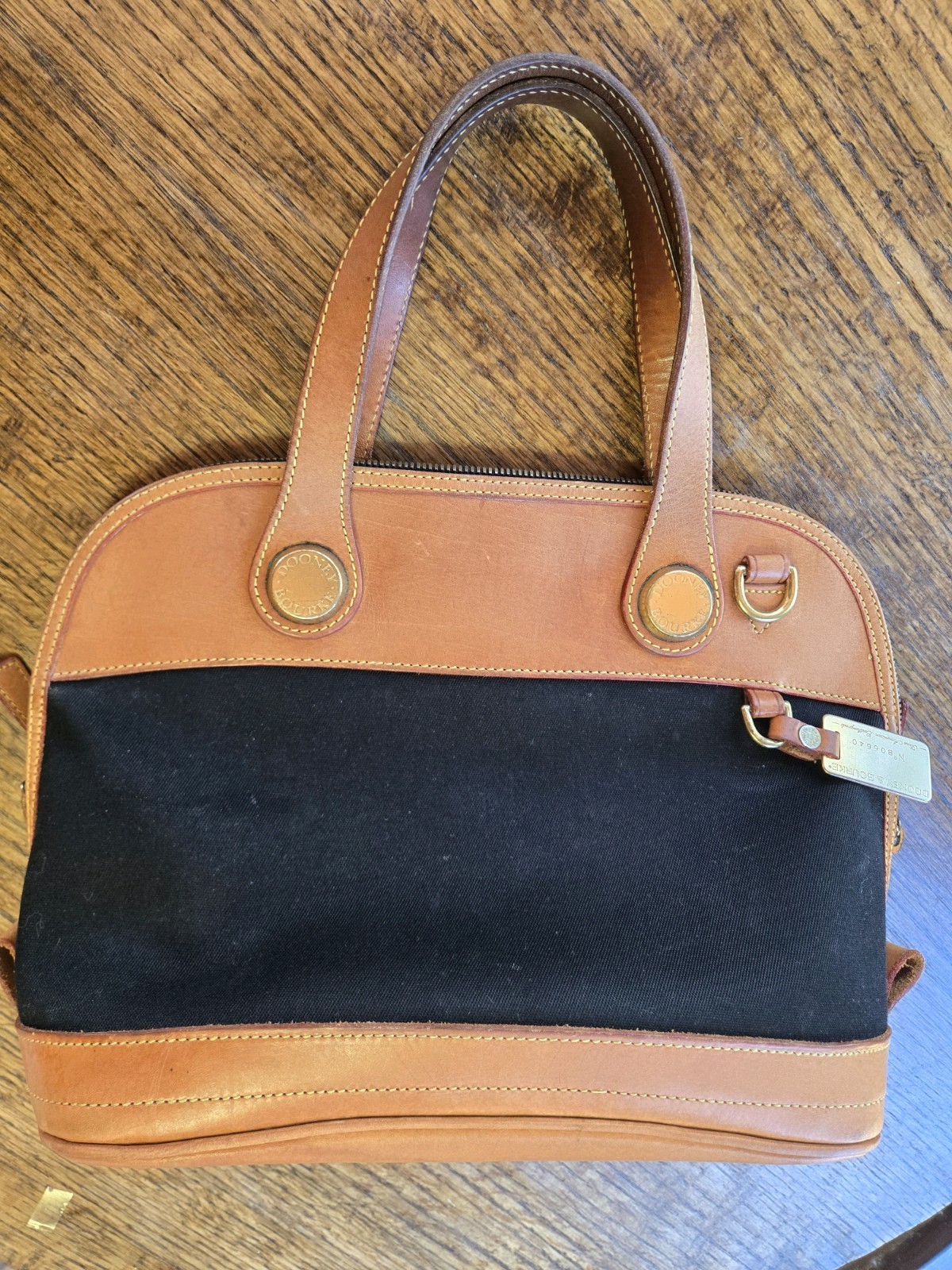 Vintage Dooney & Bourke No. B06640 Cabriolet Zip Satchel in black canvas.