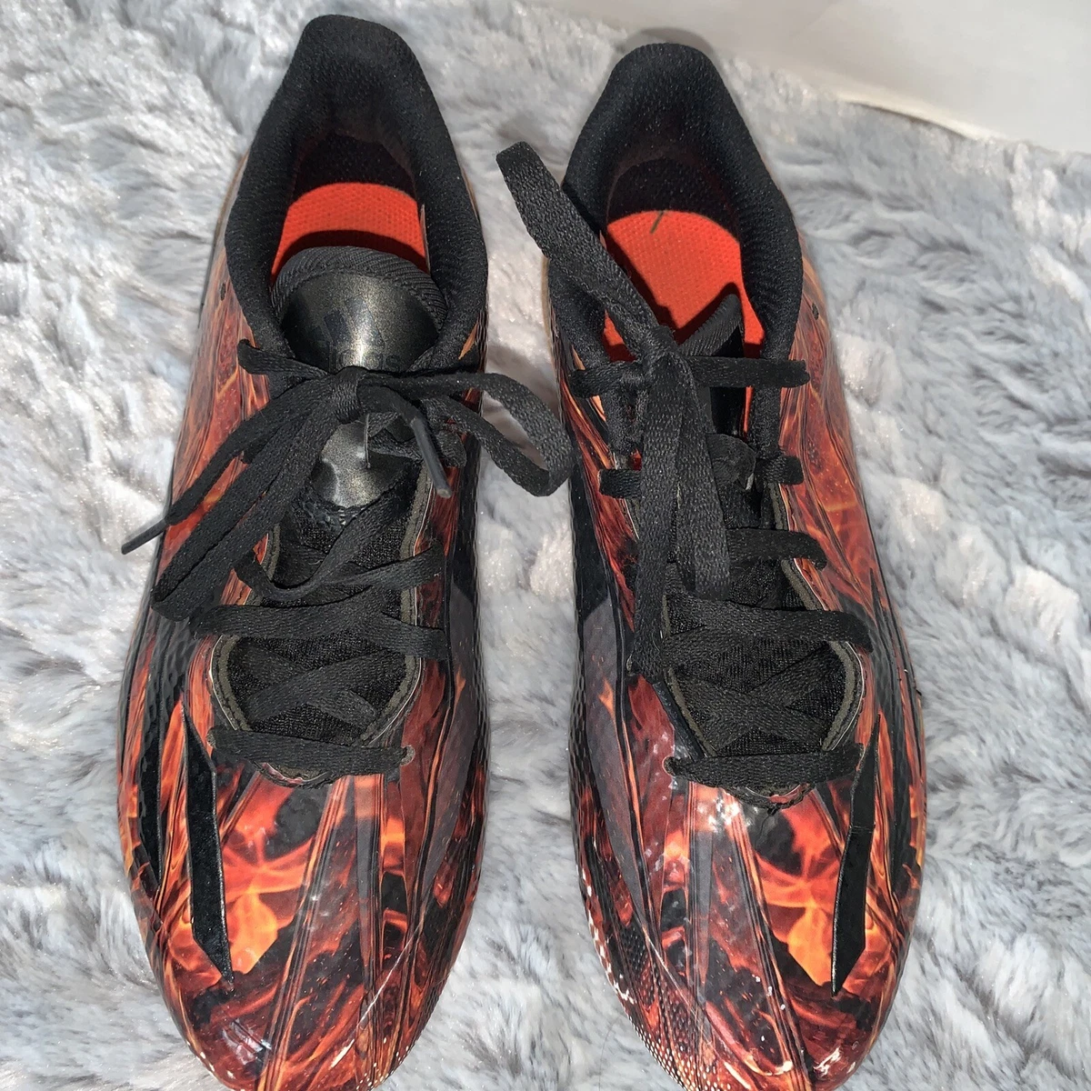 Black and orange top youth football cleats